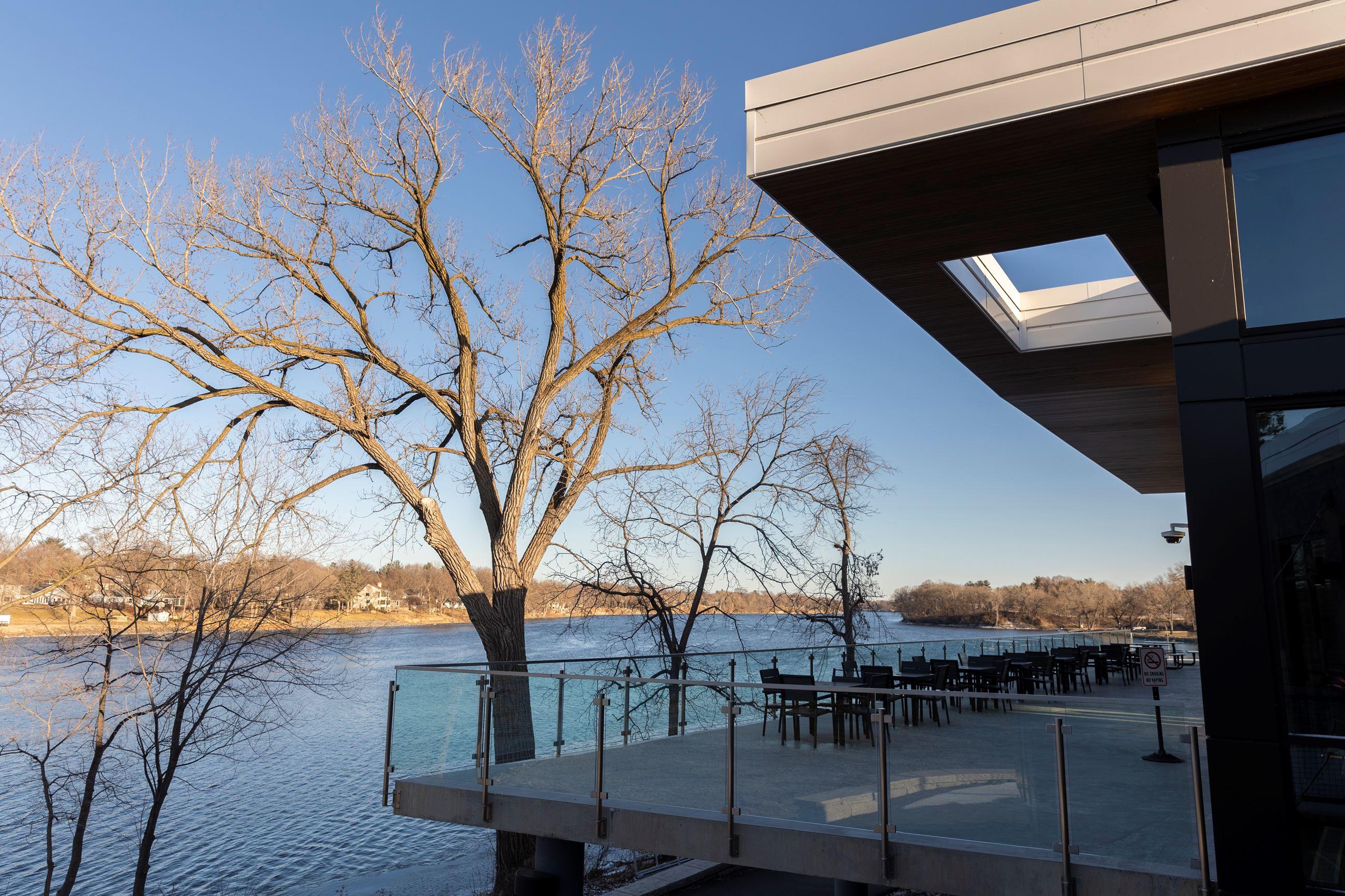 Outdoor riverfront deck and patio seating at the Mississippi Crossings Event Center in winter light